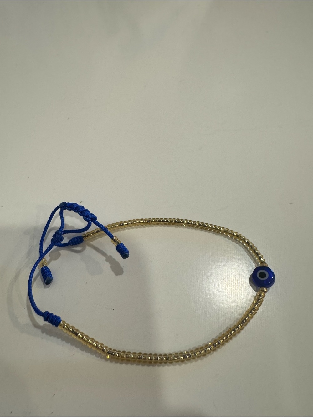 Gold Beaded Bracelet with Blue Evil Eye Charm - Adjustable